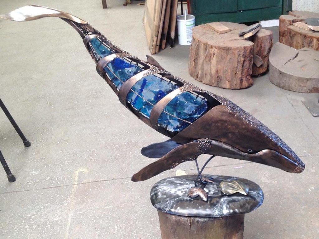 Treated steel whale inset with blue glass and a stand. #whale #handcrafted